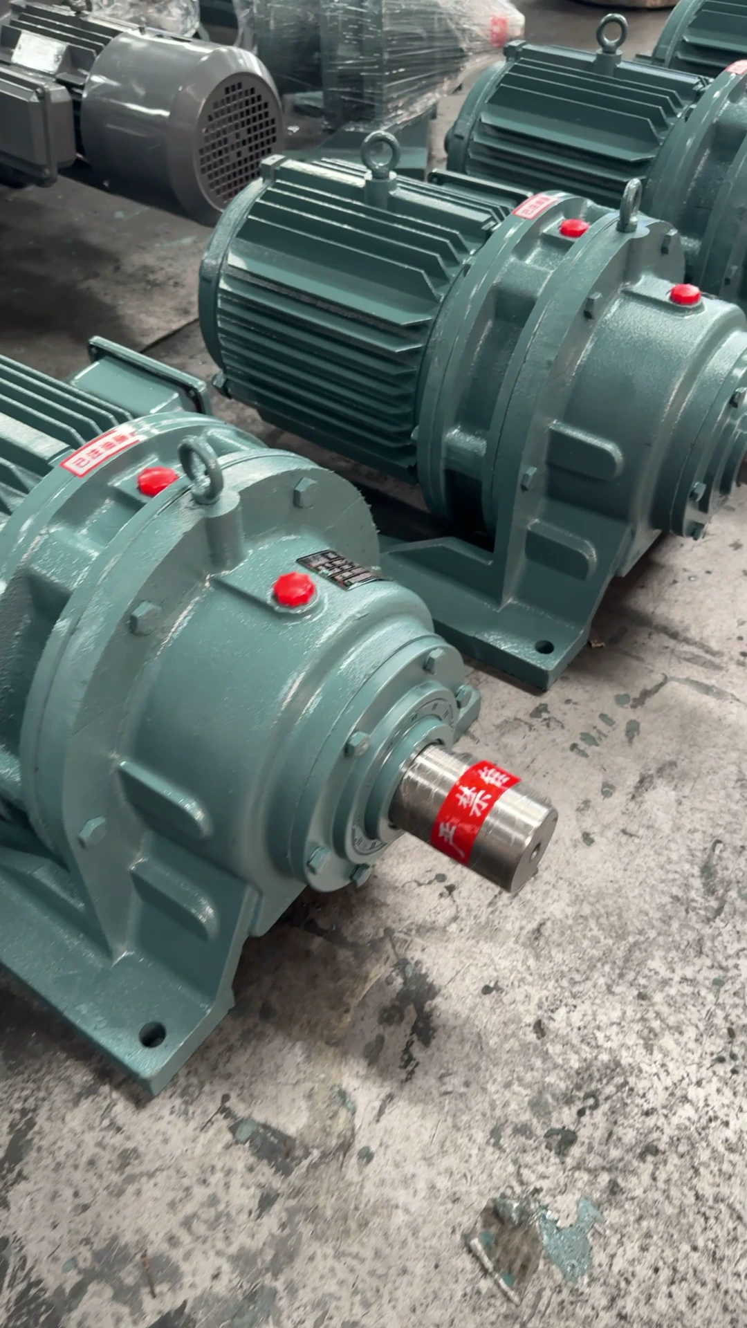 Assembled cycloidal gearmotors with visible output shafts in the workshop